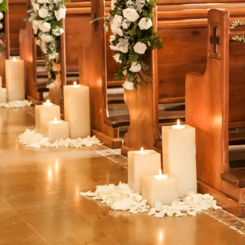 Floral wedding decorations arranged along a spotless church aisle