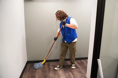 Close-up of mopping a clinic hallway floor to reduce contamination