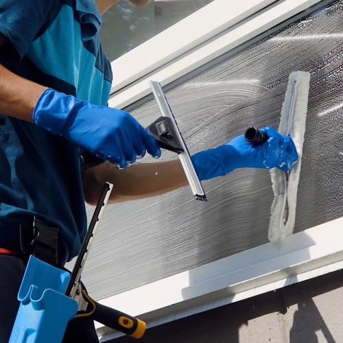 Ziva crew washing interior windows during a scheduled janitorial visit