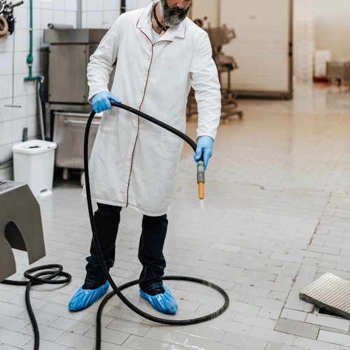 Crew scrubbing equipment and surfaces across a warehouse work zone