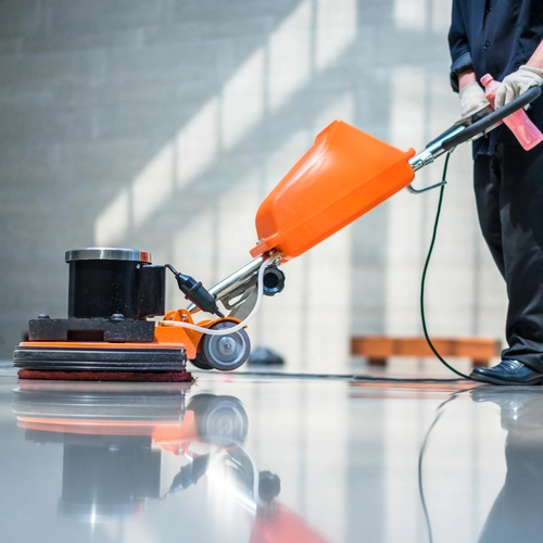 Crew performing thorough industrial cleaning across a busy manufacturing facility