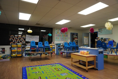 Tidy, decluttered classroom with organized shelves limiting allergen build-up