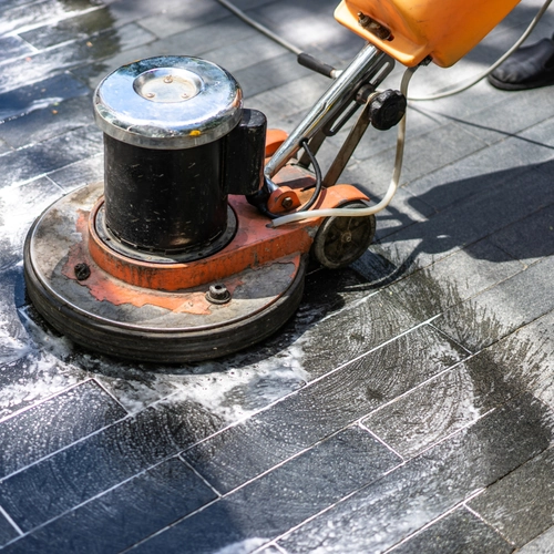 Professional cleaner tackling dust and debris in a finished construction site