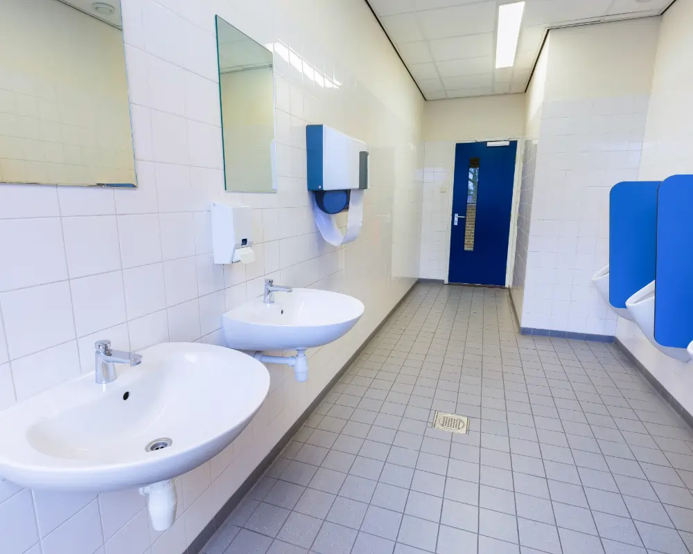 Sanitizing a school restroom to reduce germs and keep students healthy