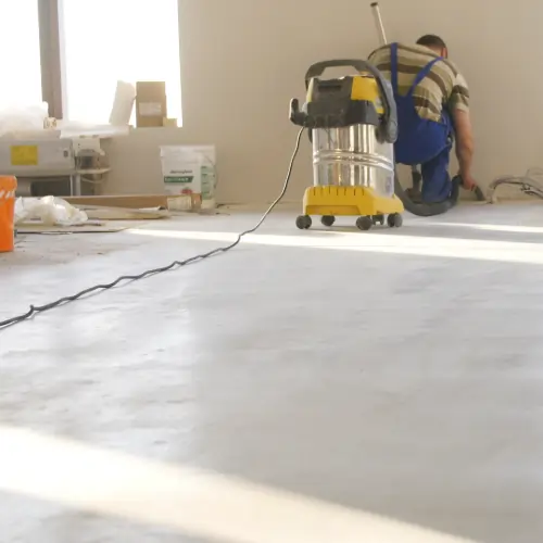 Worker wiping down surfaces while completing the post-construction cleaning checklist
